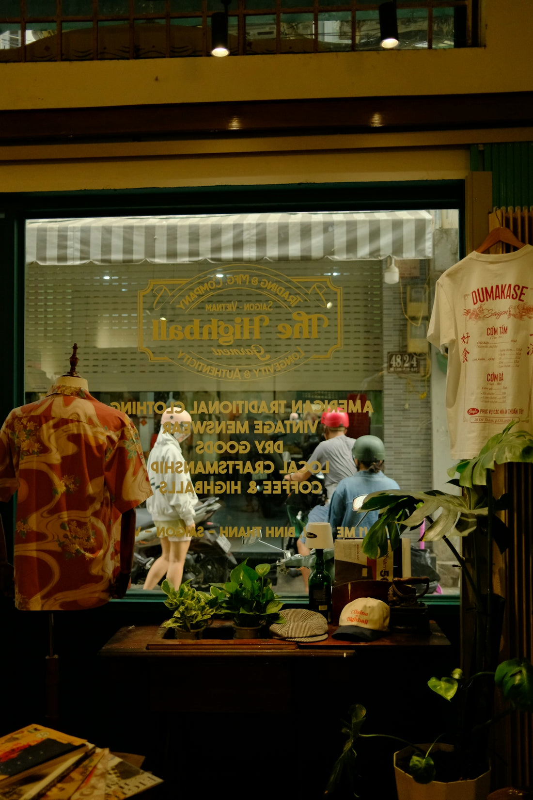 Store window display with vintage clothing and street scene