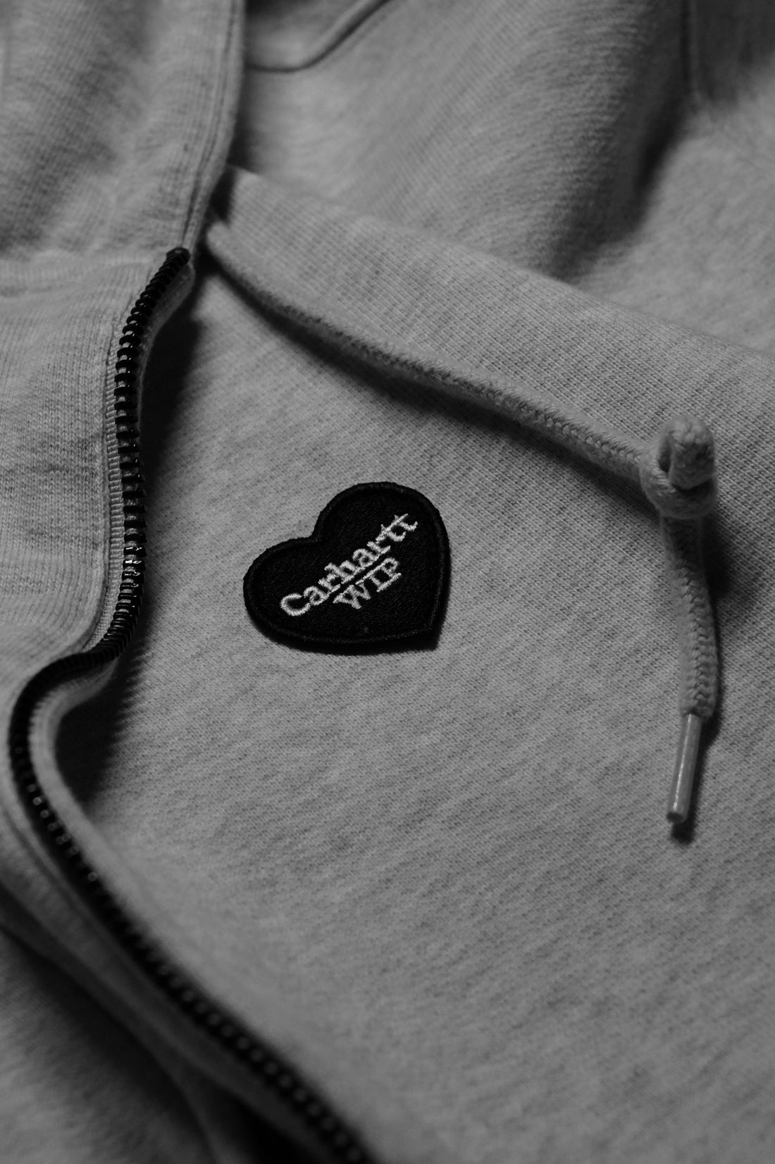 Grey hoodie with a heart-shaped carhartt wip patch